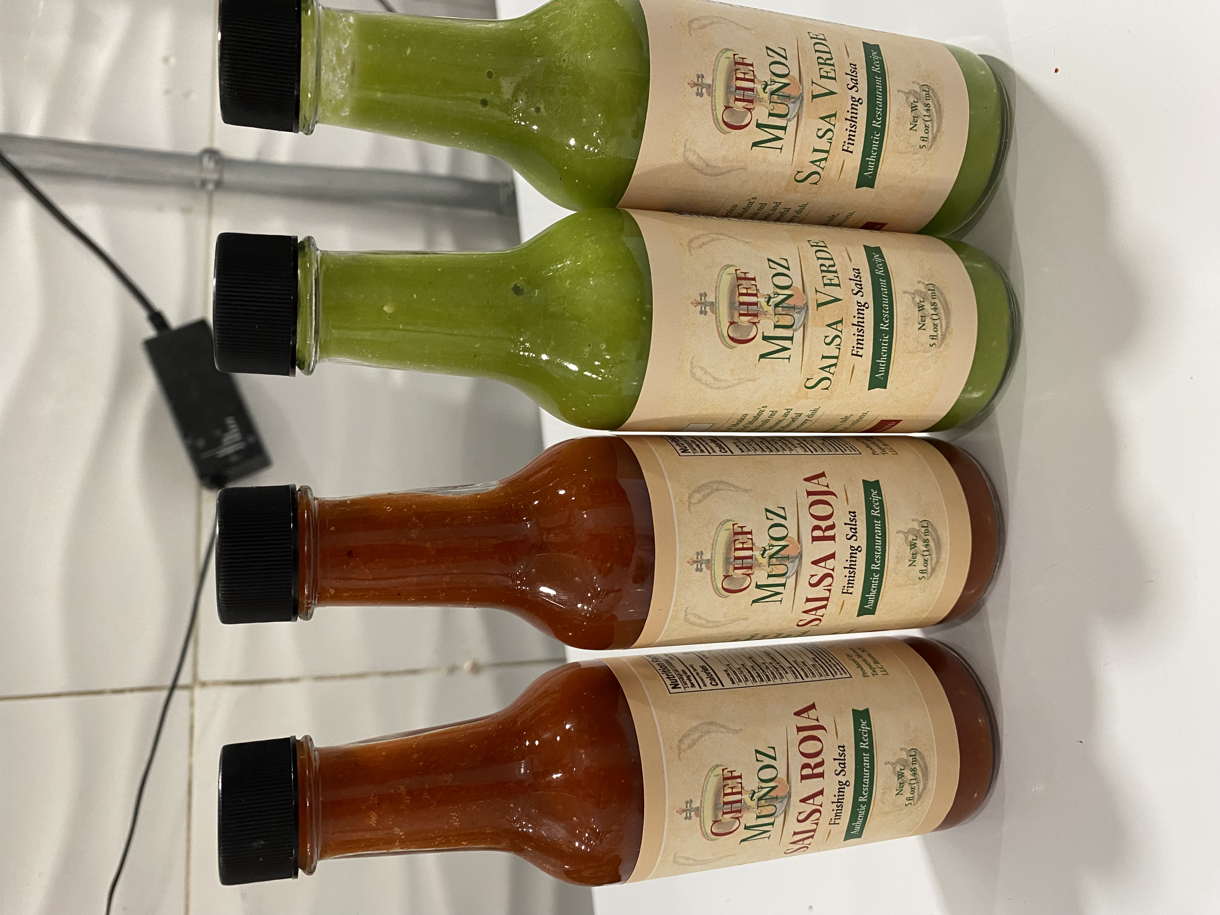 Chef Muñoz salsa roja and salsa verde prototype bottles